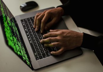 crop-cyber-spy-hacking-system-while-typing-on-laptop