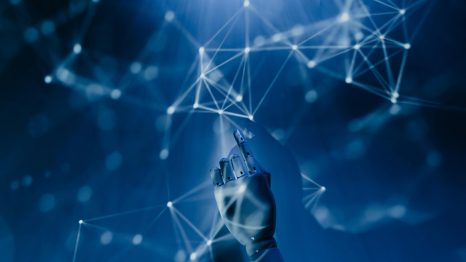 Free A robotic hand reaching into a digital network on a blue background, symbolizing AI technology. Stock Photo